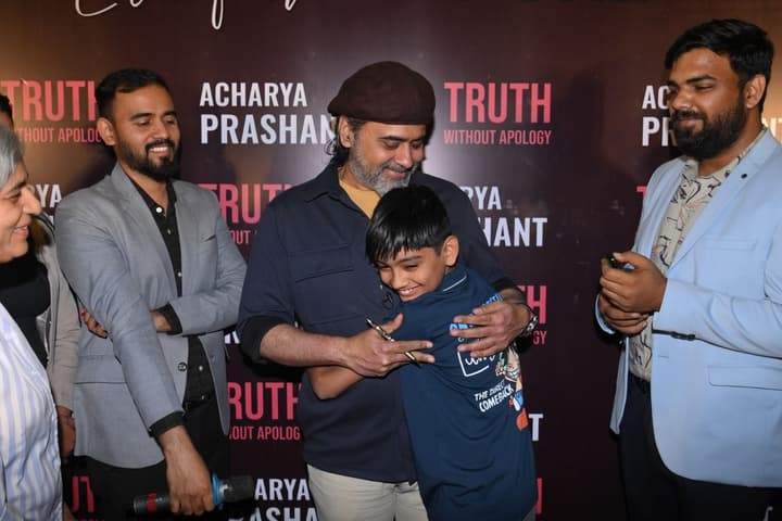 A young seeker hugging Acharya Prashant