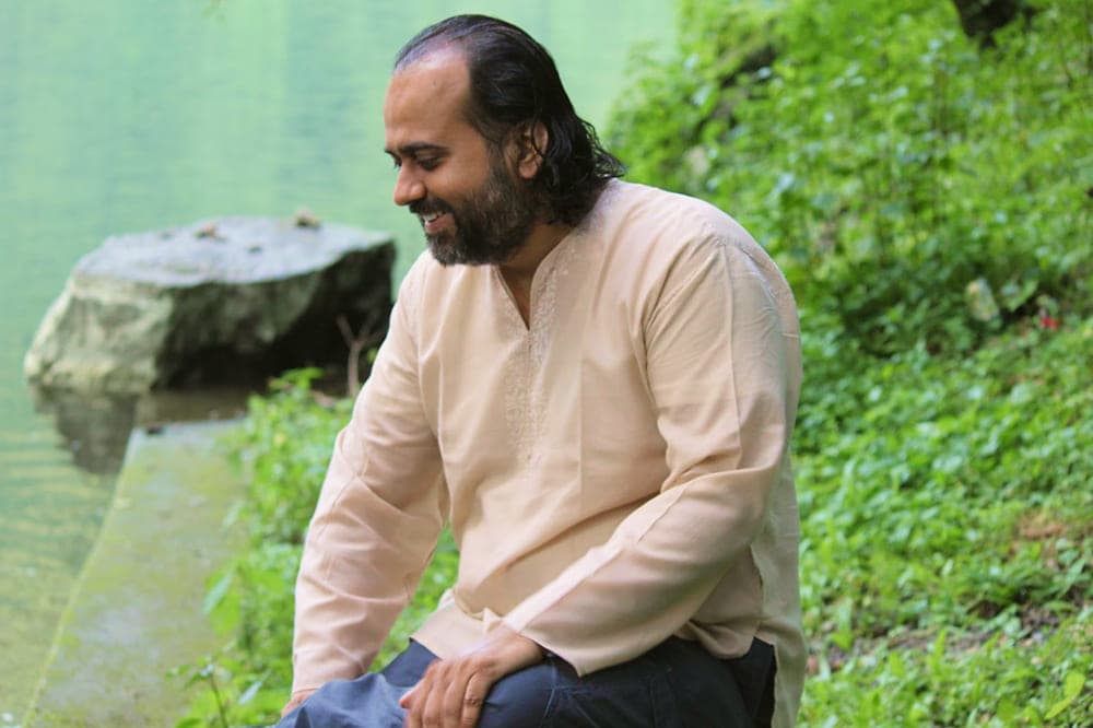 AP sitting smiling at the river bank